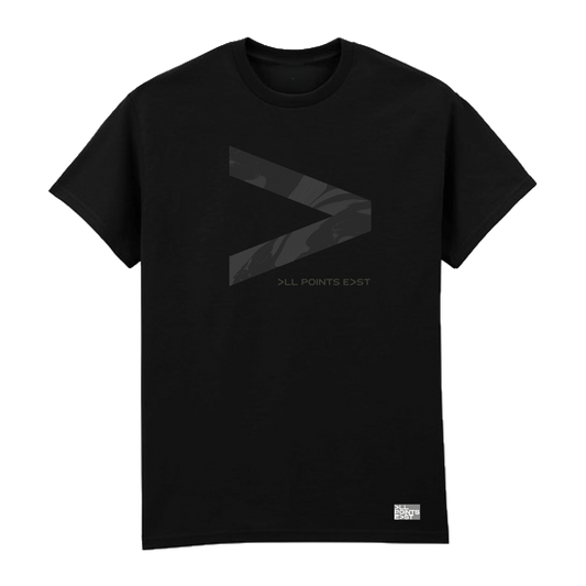 PRE-ORDER: All Points East 2026 Deftones Event T-Shirt by All Points East. This black t-shirt features a prominent dark gray greater-than symbol (>) centered on the front, with small gray “ALL POINTS EAST” text beneath it. A small white label appears at the bottom right. Available for collection at the event as official merchandise.