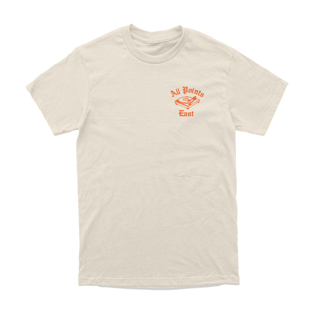 The All Points East 2026 Vinyl Player T-Shirt features a unisex tailored fit in beige, with a small orange graphic of a stylized bird and the text “All Points East” on the left chest. This eco-friendly t-shirt from All Points East offers both comfort and style, making it perfect for everyday wear.